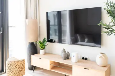 a living room with a tv on the wall at StayShort - Elegant 2 BR in Business Bay with Amazing Views that sleeps 5 in Dubai