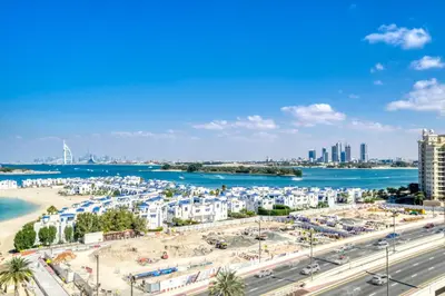 a city with a beach and buildings and the water at Shoreline 14, Al Hallawi, Palm Jumeirah - Mint Stay in Dubai