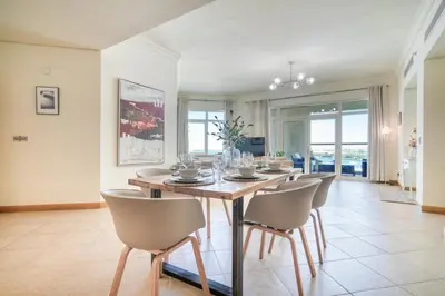 a dining room with a table and chairs at Shoreline 14, Al Hallawi, Palm Jumeirah - Mint Stay in Dubai