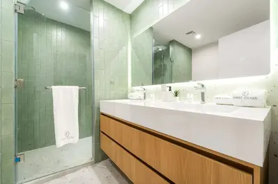 a bathroom with a sink and a shower and a mirror at FIRST CLASS 2BR Sea, Palm & Atlantis Views in Dubai