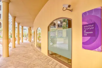 a hallway of a building with columns and a window at FIRST CLASS 2BR Sea, Palm & Atlantis Views in Dubai