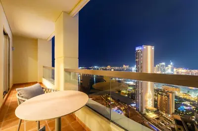 a room with a table and a view of a city at FIRST CLASS 2BR Sea, Palm & Atlantis Views in Dubai