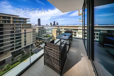 a balcony with a table and chairs on a building at Seagate by Emaar, Mina Rashed Marina, Dubai in Dubai
