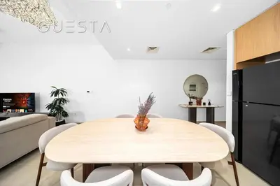 a kitchen and dining room with a wooden table and chairs at Seagate by Emaar, Mina Rashed Marina, Dubai in Dubai