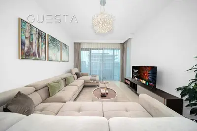 a living room with a couch and a tv at Seagate by Emaar, Mina Rashed Marina, Dubai in Dubai