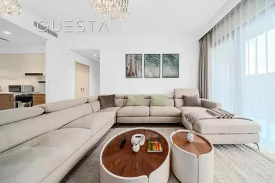 a living room with a couch and a table at Seagate by Emaar, Mina Rashed Marina, Dubai in Dubai