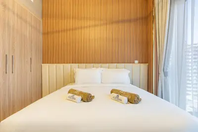 a bedroom with a bed with two pillows on it at Modern Luxe Studio in the Heart of Meydan in Dubai
