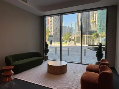 a living room with a view of a city through a large window at Chic Studio in Peninsula Three, Business Bay in Dubai