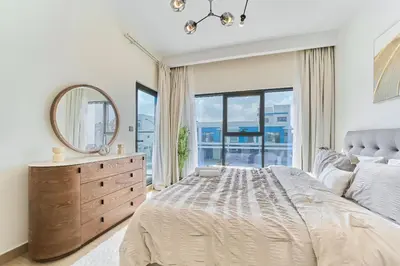 a bedroom with a bed and a mirror and a dresser at Premium 3 Bedroom Townhouse in DAMAC Lagoons in Dubai