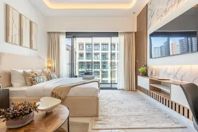 a hotel room with a bed and a large window at Open layout Studio with Balcony - Azizi Riviera 67, Al Merkadh by Deluxe Holiday Homes in Dubai