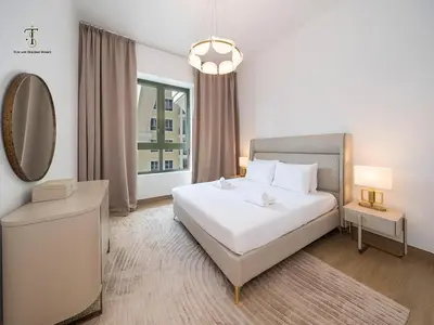 a bedroom with a large white bed and a mirror at Luxury Loft 1 Bedroom La Voile - Building 1 Jumeirah 1 in Dubai