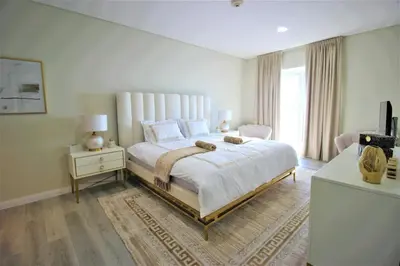 a bedroom with a large white bed and a window at Modern 2-Bedroom Apartment with JBR and Marina view on High floor in Dubai