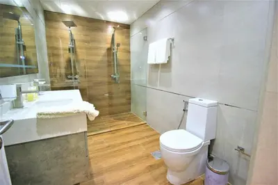 a bathroom with a toilet and a sink and a shower at Modern 2-Bedroom Apartment with JBR and Marina view on High floor in Dubai