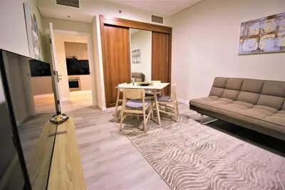 a living room with a couch and a table at Modern 2-Bedroom Apartment with JBR and Marina view on High floor in Dubai