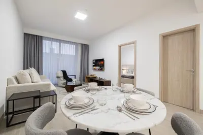 a living room with a table and chairs at Restay Homes at Luma22 West Tower in Dubai