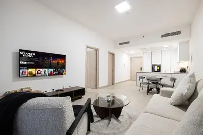 a living room with a couch and a table at Restay Homes at Luma22 West Tower in Dubai