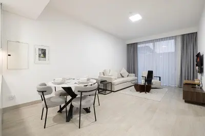 a living room with a table and a couch at Restay Homes at Luma22 West Tower in Dubai