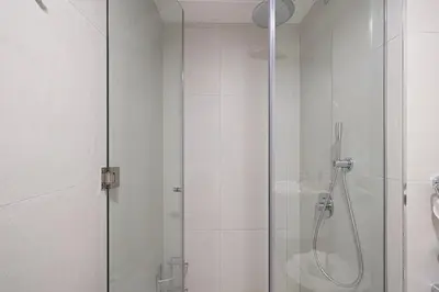 a shower with a glass door in a bathroom at Restay Homes at Luma22 West Tower in Dubai