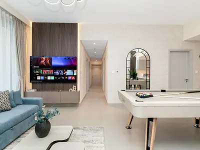 a living room with a couch and a pool table at Royal Vista25 - 4BR with Billiard Table at Forte Tower Downtown Dubai in Dubai