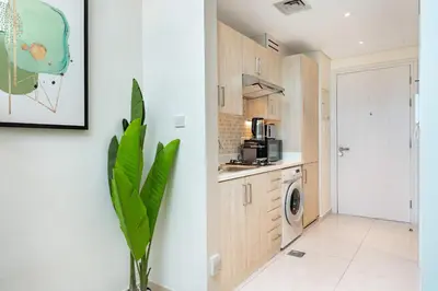 a kitchen with a plant in a room at PVH - Seven Palm - Modern Studio with Beach Access near Palm Jumeirah Mall in Dubai
