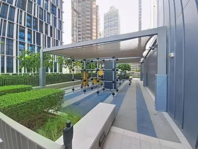 a gym with a bench in a city with tall buildings at Vacationer l Vida T2 1 Bedroom l Direct Access to Dubai Mall in Dubai