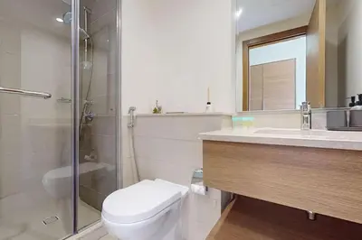 a bathroom with a toilet and a shower and a sink at Vacationer l Incredible 5 Bed l Private Garden l near Mall in Dubai
