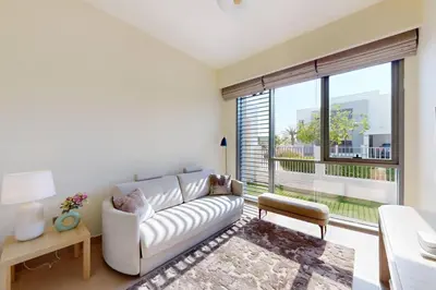a living room with a white couch and a large window at Vacationer l Incredible 5 Bed l Private Garden l near Mall in Dubai