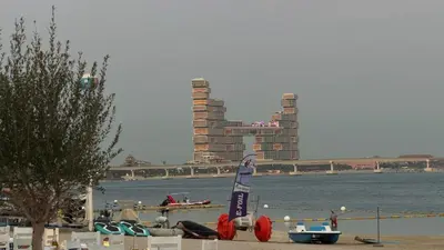 a snowboard statue on the shore of a body of water at Beachfront comfort your private escape at Palm jumeriah th8 residences in Dubai