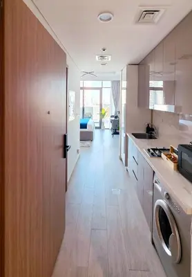 a kitchen with a washer and dryer in a room at Modern Deluxe Studio in Dubai in Dubai