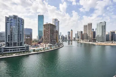 a view of a city with a river and buildings at Frank Porter - Damac Maison Prive in Dubai