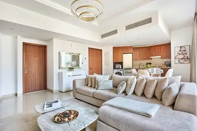 a living room with a couch and a table at Frank Porter - Boulevard Point in Dubai