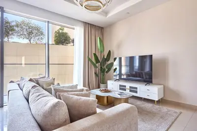 a living room with a couch and a flat screen tv at Frank Porter - Boulevard Point in Dubai