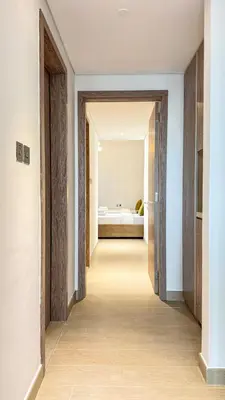 a hallway leading to a bedroom with a bed at Stylish 2 Bed with full marina view on high floor in Dubai