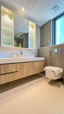 a bathroom with a sink and a toilet and a mirror at Stylish 2 Bed with full marina view on high floor in Dubai