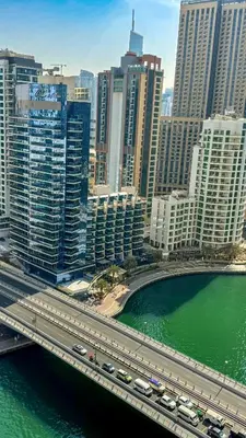 a city with a bridge over a river and buildings at Stylish 2 Bed with full marina view on high floor in Dubai