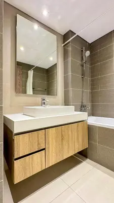 a bathroom with a sink and a mirror and a tub at Stylish 2 Bed with full marina view on high floor in Dubai