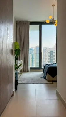 a bedroom with a bed and a large window at Stylish 2 Bed with full marina view on high floor in Dubai