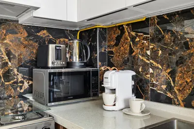 a kitchen with a microwave and a coffee maker at BLVD Modern Stay in Jewelz -Balcony Pool & Gym in Dubai