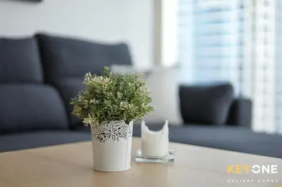 a white vase with a plant on a table at Spectacular Marina Views Luxurious Two Bedroom in Dubai