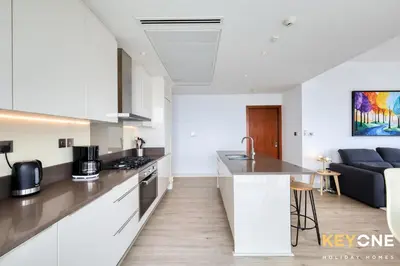 a kitchen and a living room with a couch at Spectacular Marina Views Luxurious Two Bedroom in Dubai