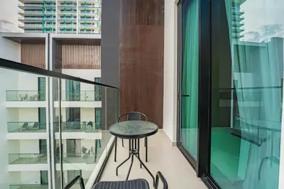 a small table on the balcony of a building at HAVN - Studio in Binghatti Dawn, JVC in Dubai