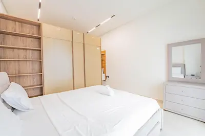 a bedroom with a large white bed and a window at HAVN - Studio in Binghatti Dawn, JVC in Dubai