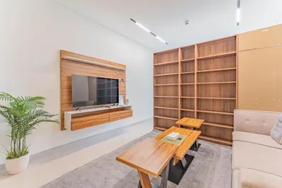 a living room with a tv and a couch and a table at HAVN - Studio in Binghatti Dawn, JVC in Dubai