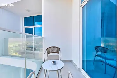 a balcony with a table and chairs on a building at bnbmehomes - Skyz by Danube in Dubai