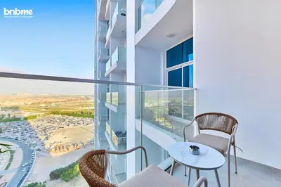 a balcony with a table and chairs on a building at bnbmehomes - Skyz by Danube in Dubai
