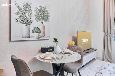a dining room with a table and chairs at bnbmehomes - Skyz by Danube in Dubai