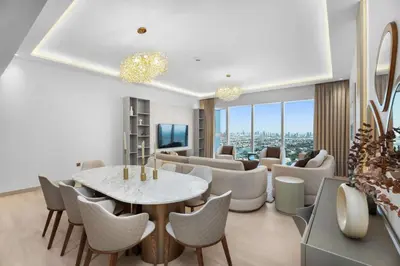 a living room with a table and chairs at Spacious 3BR and Study with Multiple Ensuites Medore Residence in Dubai