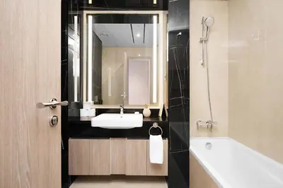 a bathroom with a sink and a mirror and a tub at Spacious 3BR and Study with Multiple Ensuites Medore Residence in Dubai