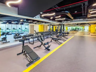 a gym with a lot of treadmills and machines at Spacious 3BR and Study with Multiple Ensuites Medore Residence in Dubai
