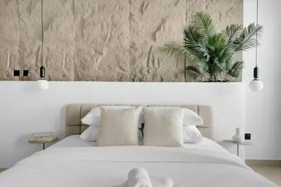 a bedroom with a white bed with white pillows at GuestReady - 3BR | Luxury High-Rise Escape in Dubai